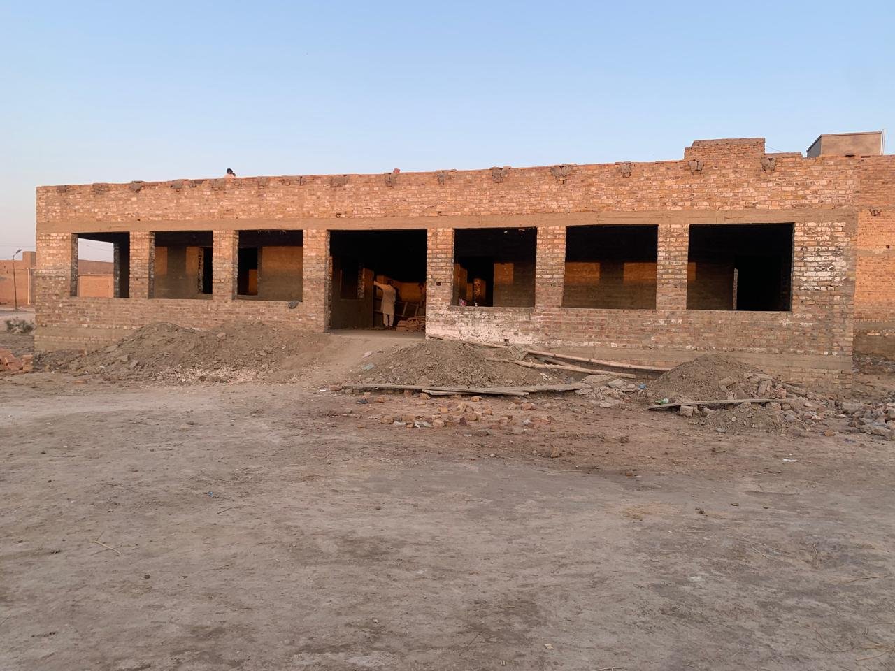 "A promotional poster for 'Sensei Challenge II: 10K Row-A-Thon' benefiting the Gaza Emergency Appeal. The poster features a dark teal background with prominent orange and white text. At the top are the logos of UK Relief (showing hands holding a globe) and Fitness 4 Life (featuring a cartoon martial arts character). The event details show it's scheduled for Saturday 11th October 2025 at 11AM at Portloop Edgbaston. The poster includes a '100% Donation Policy' badge in orange. The central image shows a Palestinian flag against a background of damaged buildings. The poster also includes two additional photos: one showing red and yellow kayaks or rowing equipment lined up by a dock, and another showing a group of participants at what appears to be a previous event. Contact information is provided for three organizers (Ifti, Shaf, and Sensei) with their phone numbers. The poster includes UK Relief's banking details with Sort Code: 309950, Account Details: 80457568, and Reference: Emergency Relief. The UK Charity Registration number 1203422 is displayed in the top right corner. The overall design effectively combines the sporting challenge aspect with the humanitarian cause, using a color scheme of orange, white, and blue against the teal background."